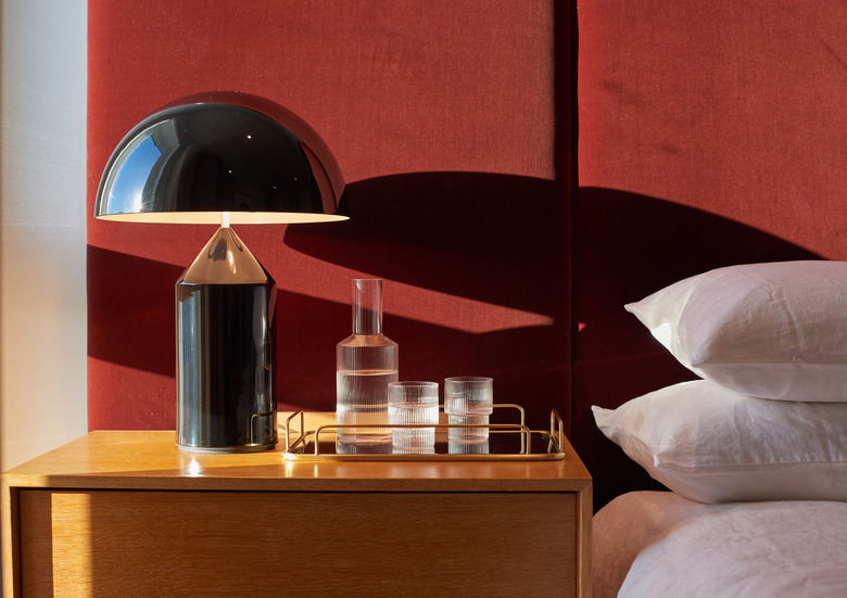 bedroom with red velvet headboard