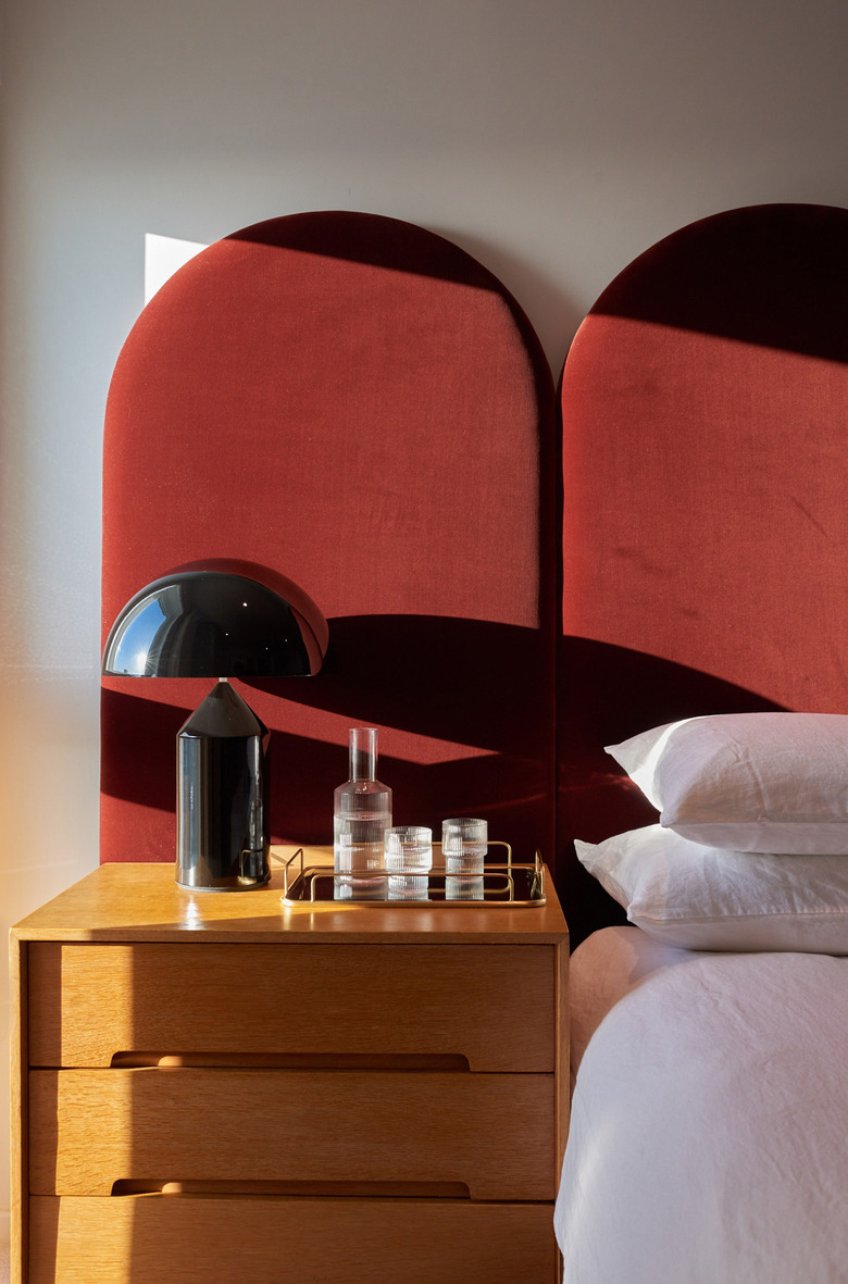 bedroom with red velvet headboard