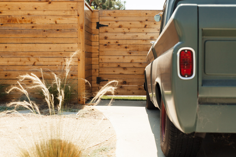 truck outside wood fence