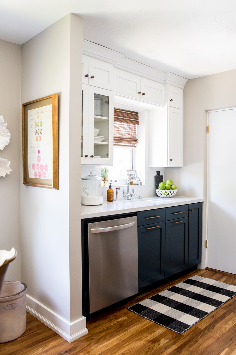 small kitchen with white and blue cabinets