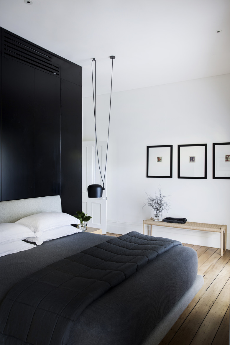 Bedroom with black accent wall.