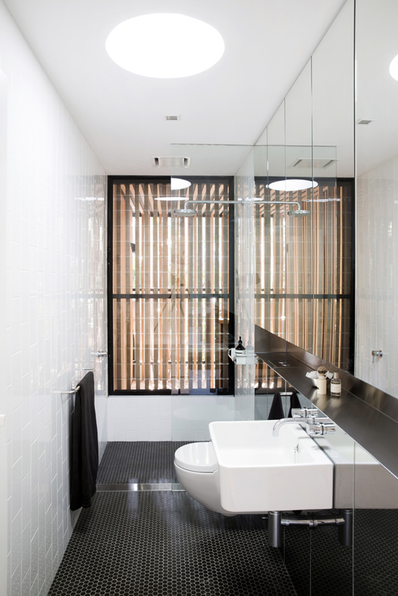 Bathroom with white tiled wall.