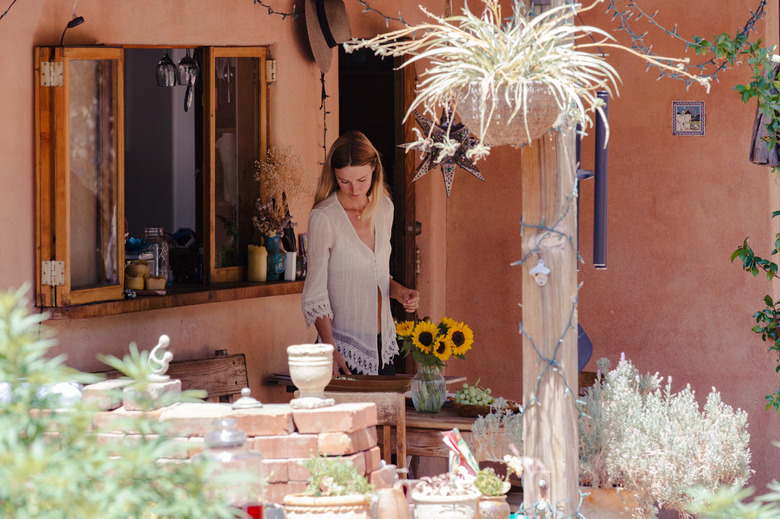 shot of exterior patio with Colleen setting the table