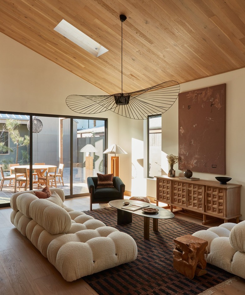 family room with hanging light fixture and off-white plush couches
