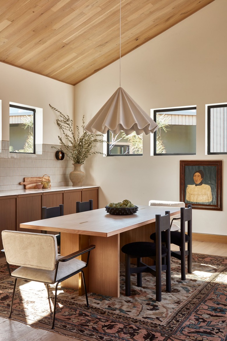 dining room area with large light fixture and wood ceilings