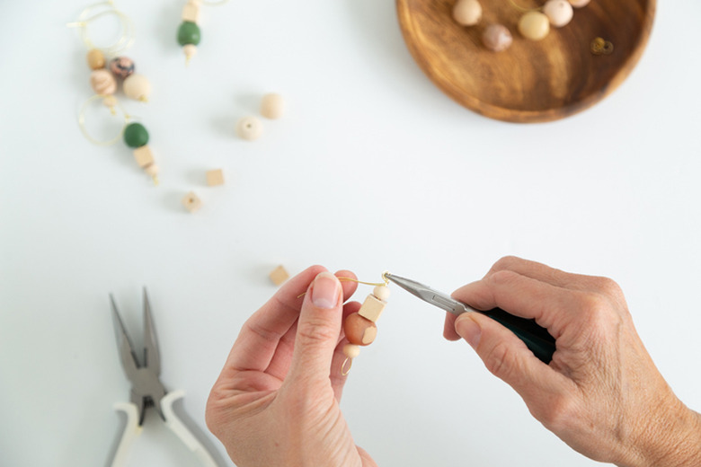 Putting wood and clay beads onto jewelry wire