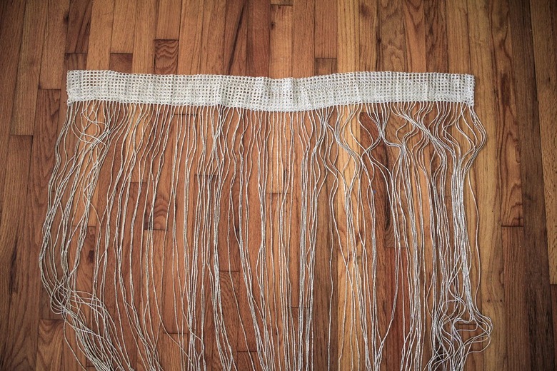 Neutral curtain fringe on wood floor