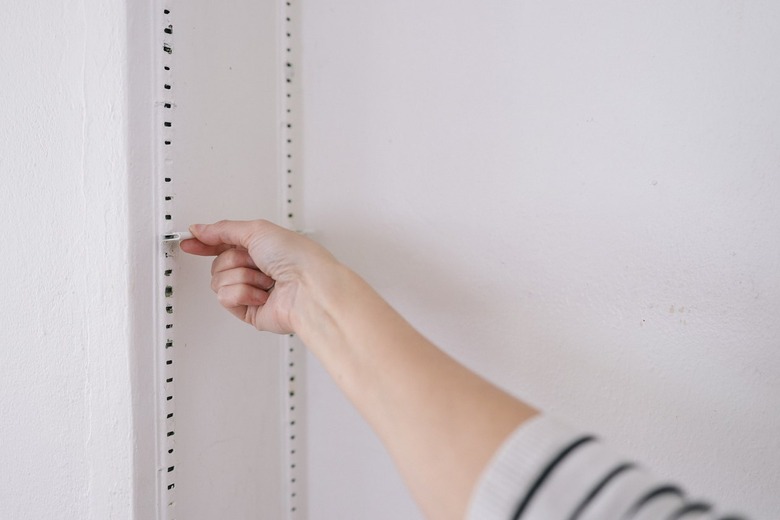 Removing shelf bracket clip from shelving track