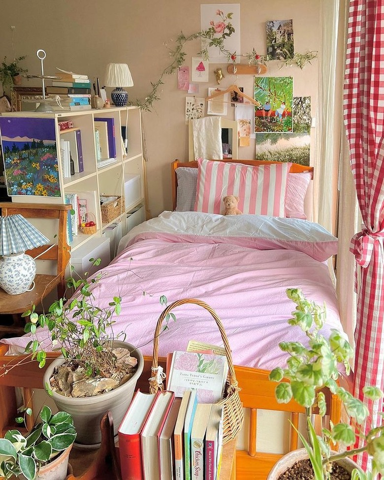 bedroom with pink sheets in filtered morning light