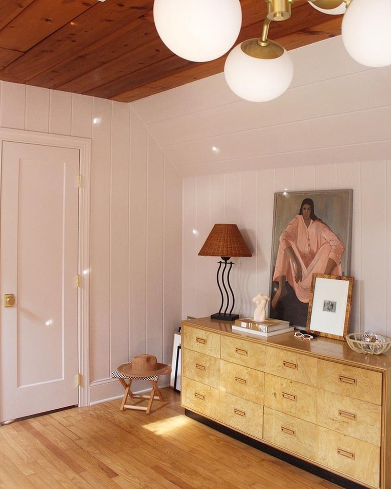 bedroom with vintage dresser and light from disco ball reflecting on walls