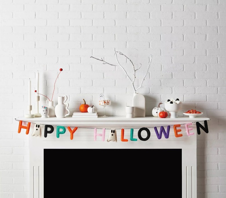 A white fireplace with white vases