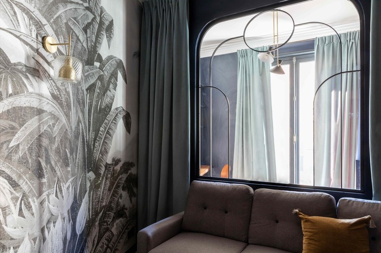 Tropical wallpaper lines the TV room.