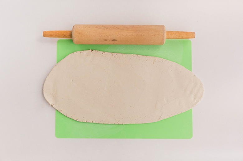 Roll clay out flat until it's about 1/4-inch thick.