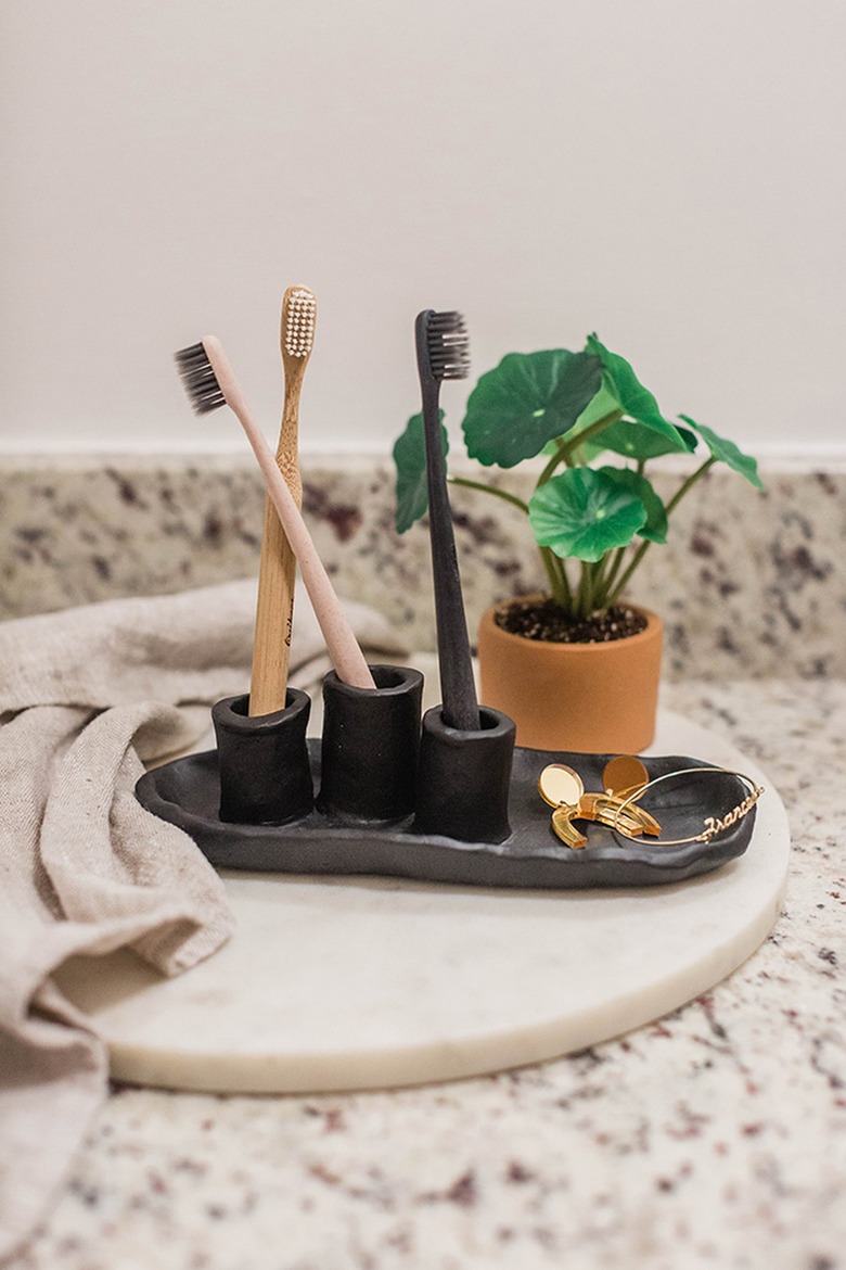Air-dry clay toothbrush holder on bathroom vanity