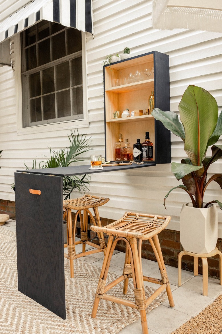 Patio with a black plywood bar table-cabinet set