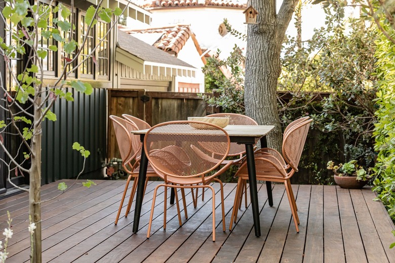 Wood deck with retro pink chairs