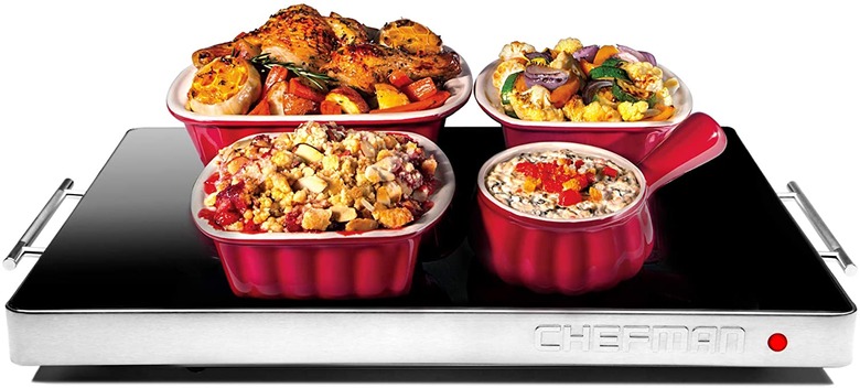 black and silver warming tray with dishes on top