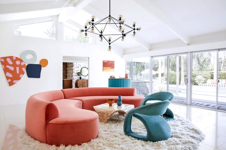 A white room with a curved red couch