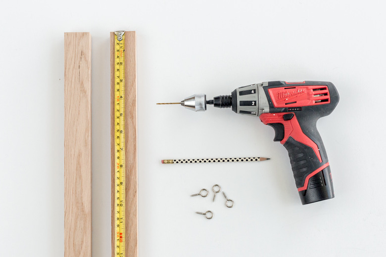 Drill pilot holes for eye hooks.