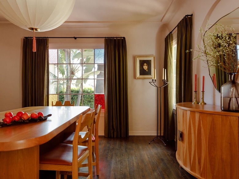 dining room with violet-mauve colored walls and dark curtains