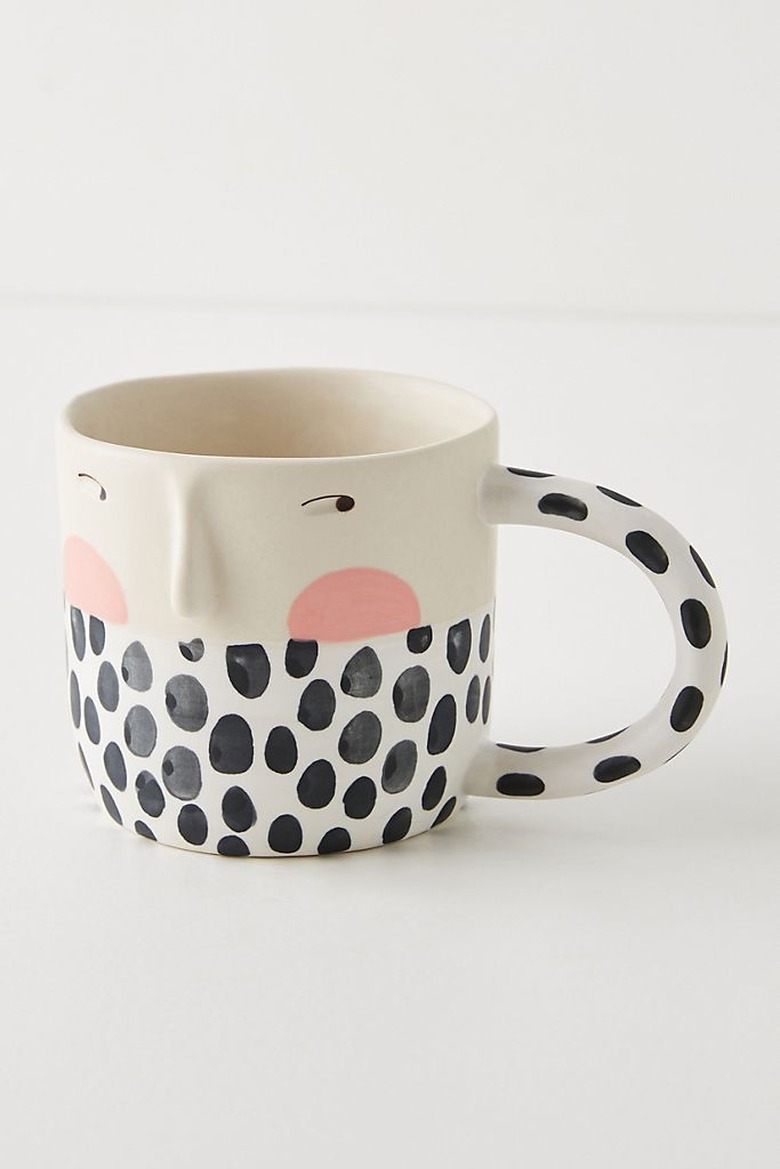 mug with black and white pattern and drawn face