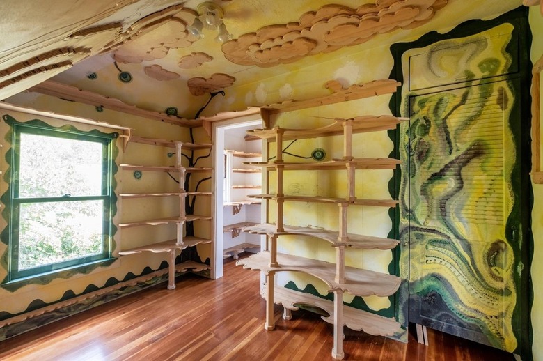 Room with wooden shelves and designs on the ceiling