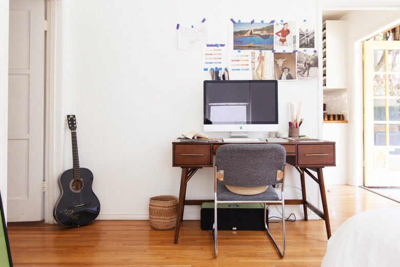 Home office with wood floors and guitar