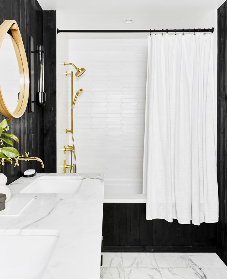 art deco bathroom by Emily Henderson Design with black walls and marble floor