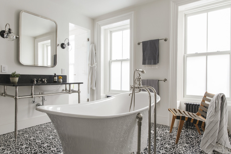art deco bathroom by Elizabeth Roberts Architecture with freestanding tub and console sink