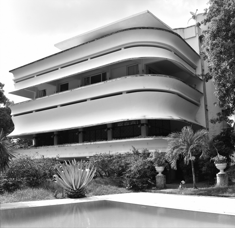 Modernist building with streamlined balconies and white exterior