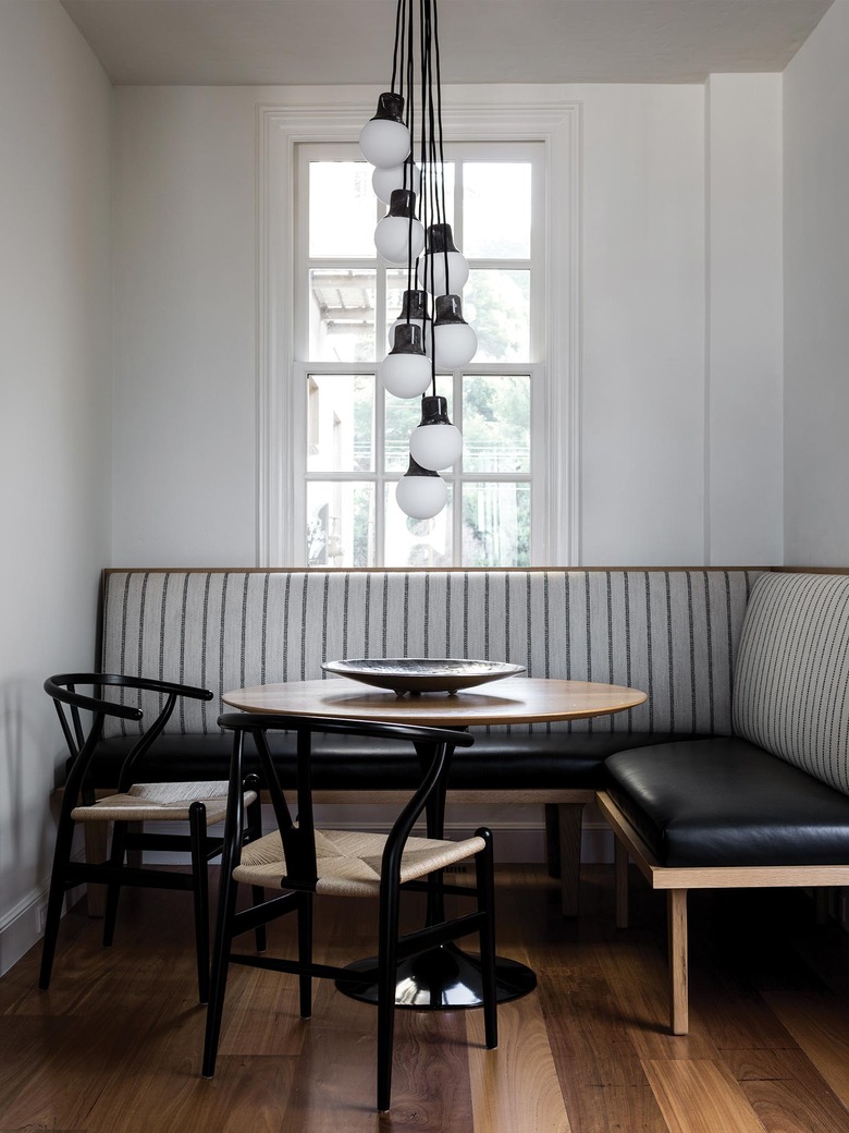 breakfast nook with banquette seating and clustered light fixture
