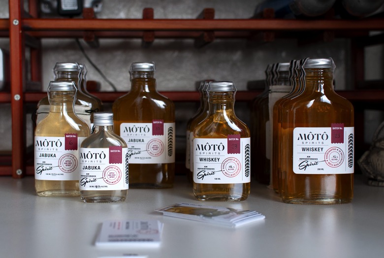 MÔTÔ SPIRITS bottles on white counter