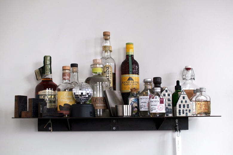 Floating shelf with various liquor bottles