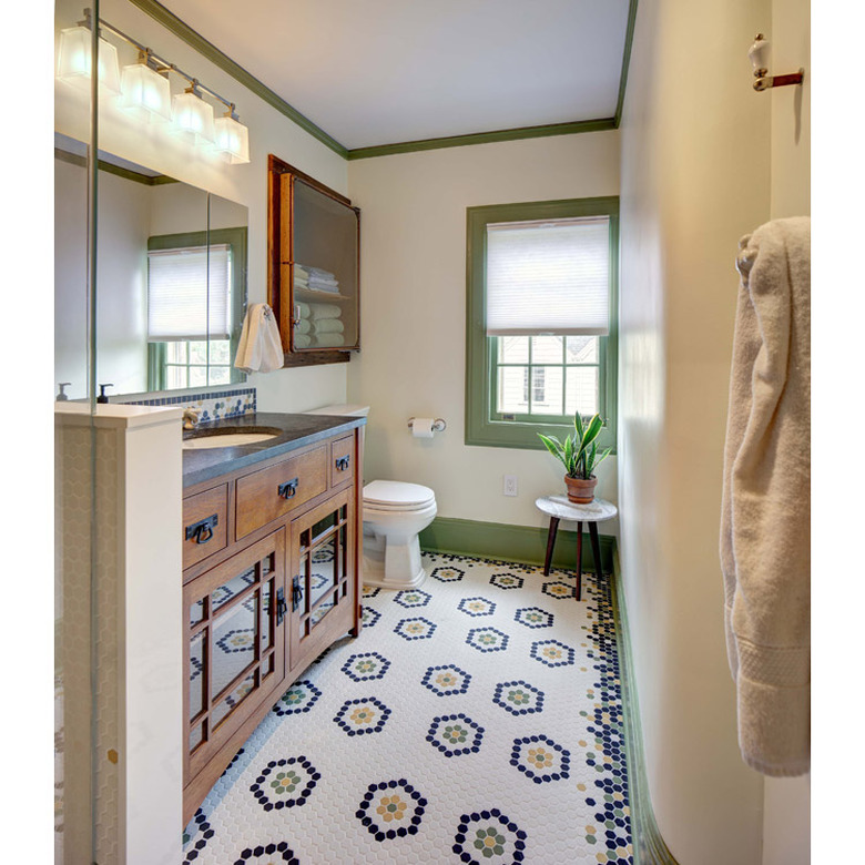 arts and crafts bathroom with patterned hex floor tile and green painted trim