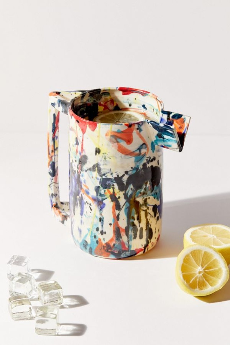 pitcher in various colors near lemons