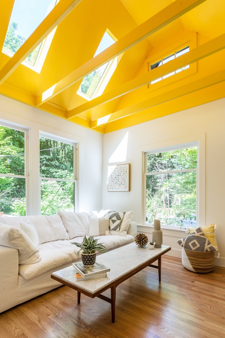 living room area with bright yellow ceiling