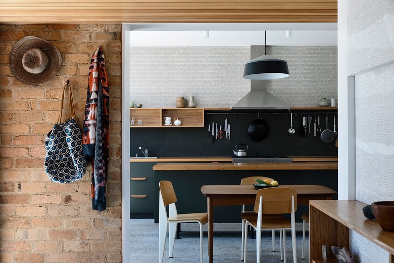 view of dining and kitchen area with wood accents