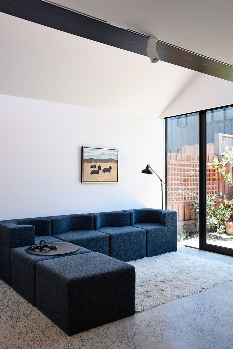 modular sofa in living room with large glass doors nearby