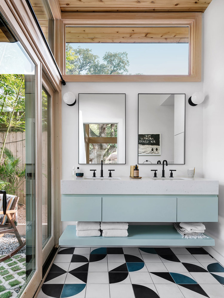 Bathroom with blue vanity and geometric tile