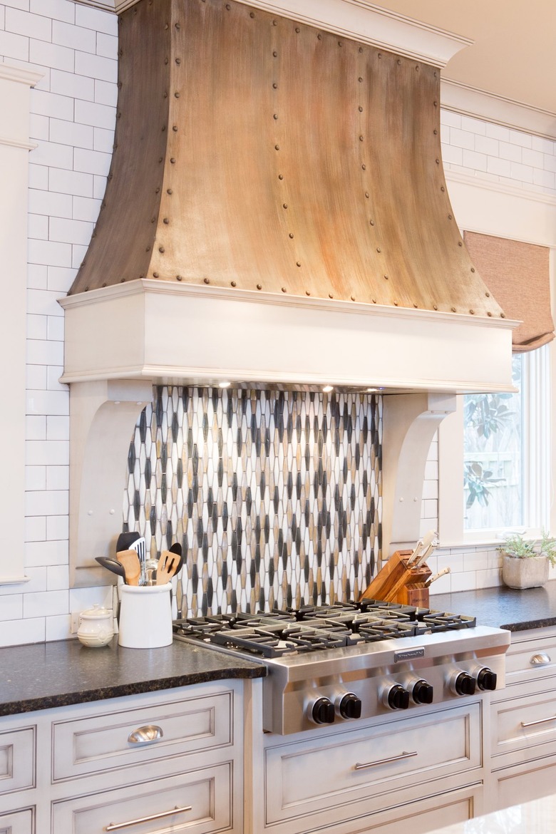 Bronze backsplash with white kitchen cabinets