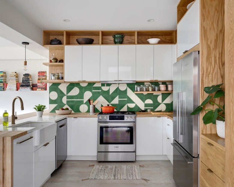 Green backsplash with white cabinets