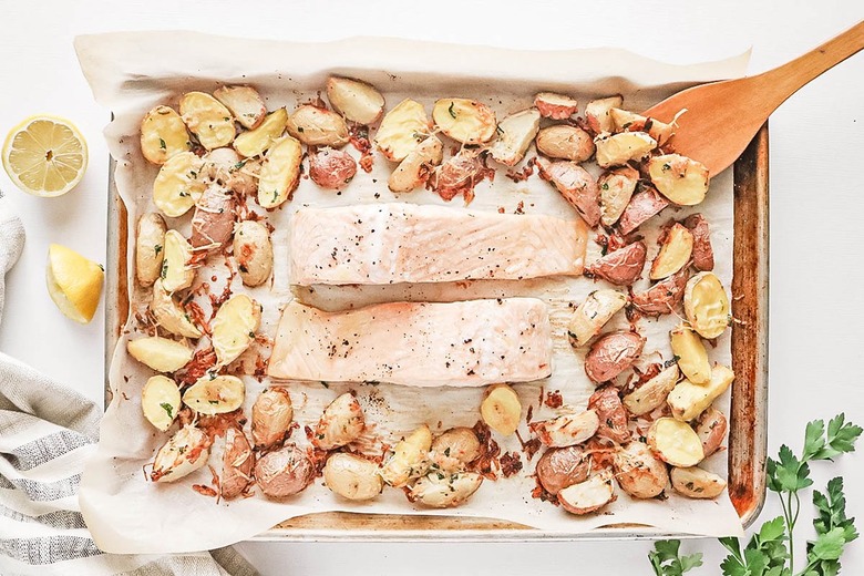Baked salmon and potatoes on a baking sheet