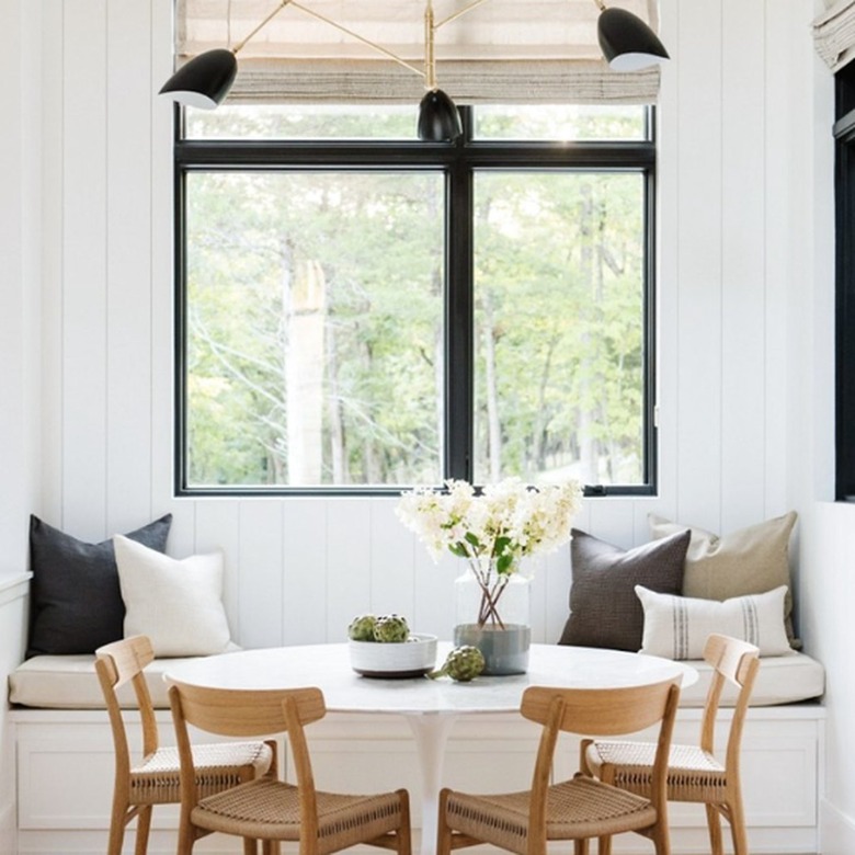 Banquette seating in kitchen with white round table