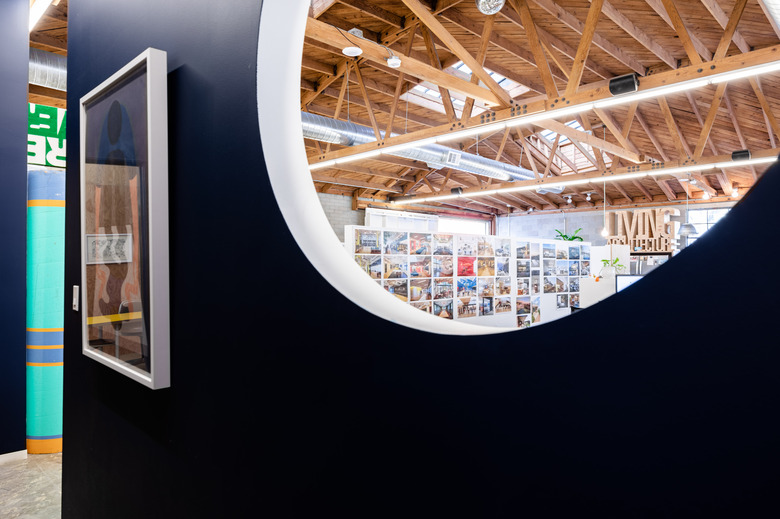 Indoor circular window looking out into warehouse office space
