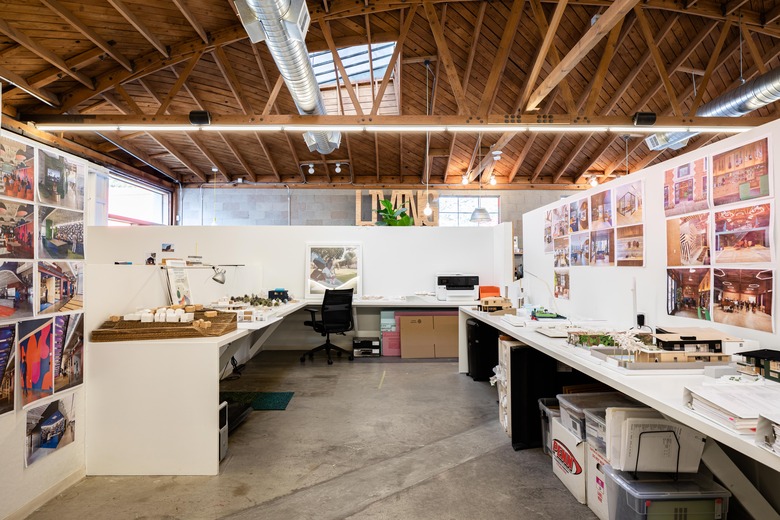 Office space with white texts and walls below high wood-beam ceilings