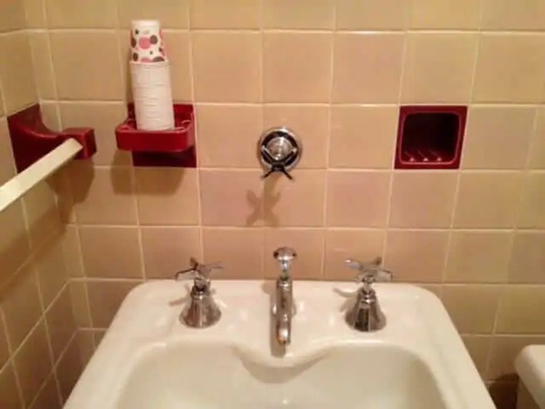 An ice water tap above the bathroom sink in a 1930s home