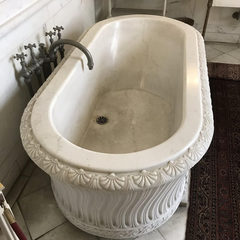 A Gilded Age tub carved from a single slab of marble featuring hot and cold saltwater taps.