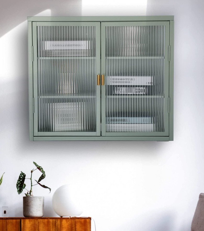 green cabinet filled with books and knickknacks