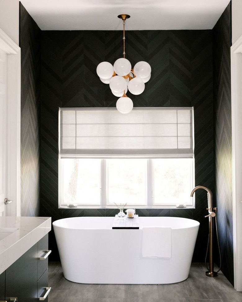 Black bathroom with orb pendant light.