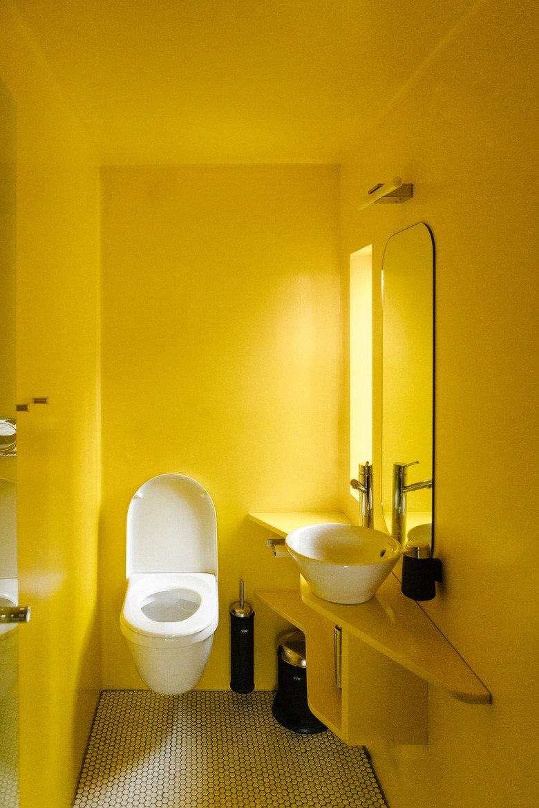Minimalist yellow-walled bathroom with sink